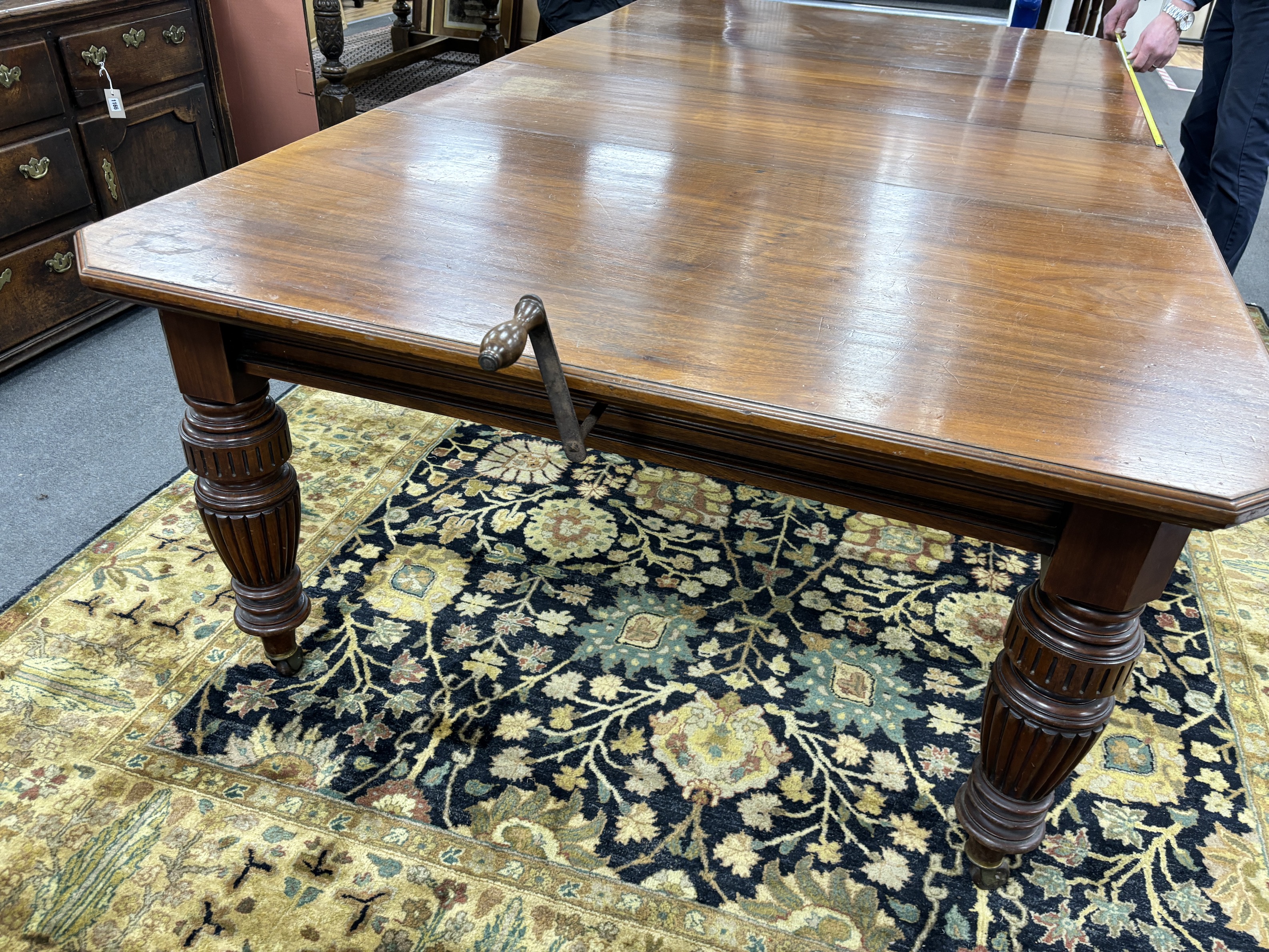 A late Victorian walnut extending dining table, on turned fluted baluster legs, 240cm extended, two spare leaves, depth 137cm, height 73cm